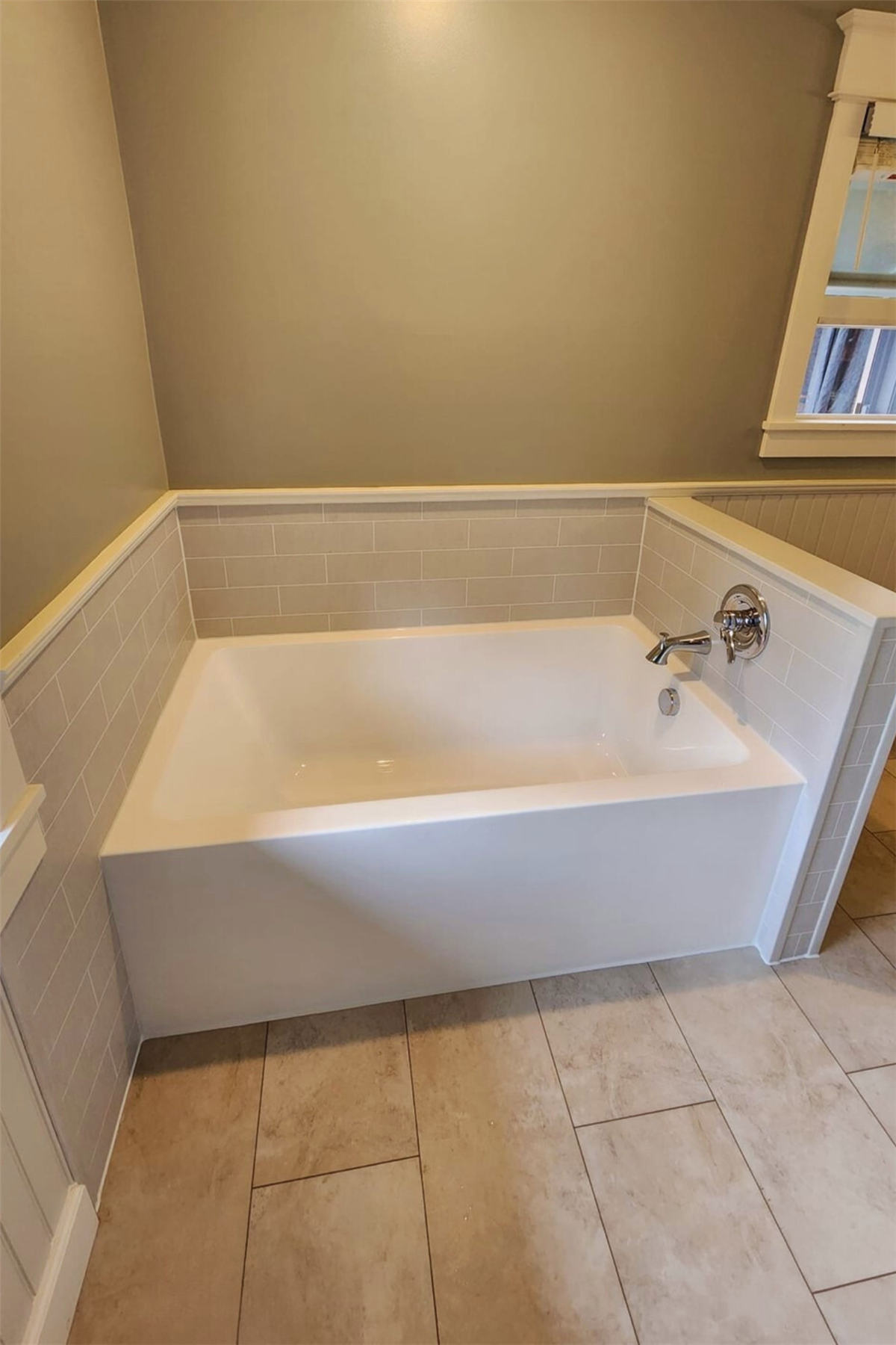 New white replacement tub with light gray tile-look wall surround