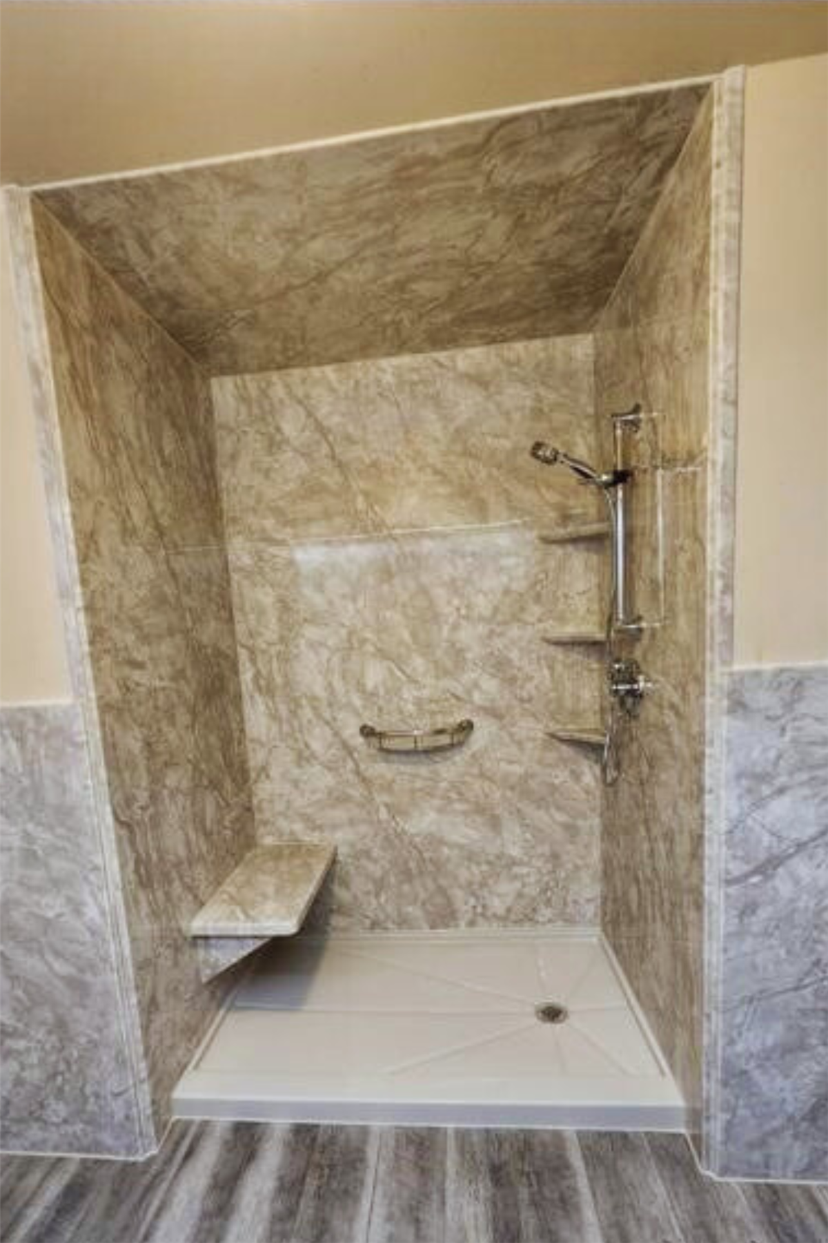Stone-look shower surround with built-in corner shelves and grab bar