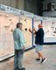 Bathroom remodeling specialist showing a shower wall sample to a customer