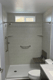 Gray tile-look shower surround with stainless steel grab bar