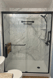 Marble-look tub-to-shower conversion with stainless steel safety grab bar