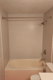New bathtub with smooth beige wall surround