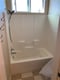 White bathtub surround with built-in shelves after bathroom remodeling