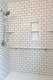 White subway tile shower conversion with recessed storage niche